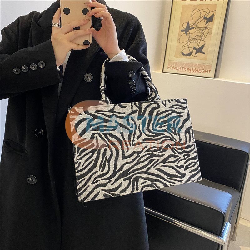 Zebra Hand Holding Bag